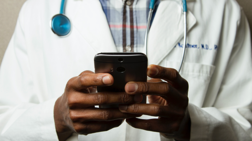 Photo of a doctor holding a smartphone