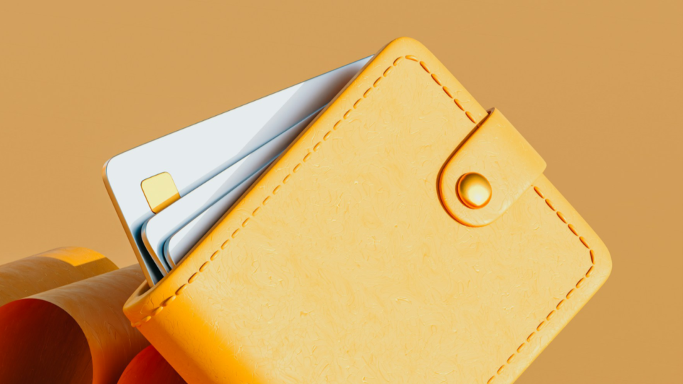 3d render of an orange wallet displaying white credit cards