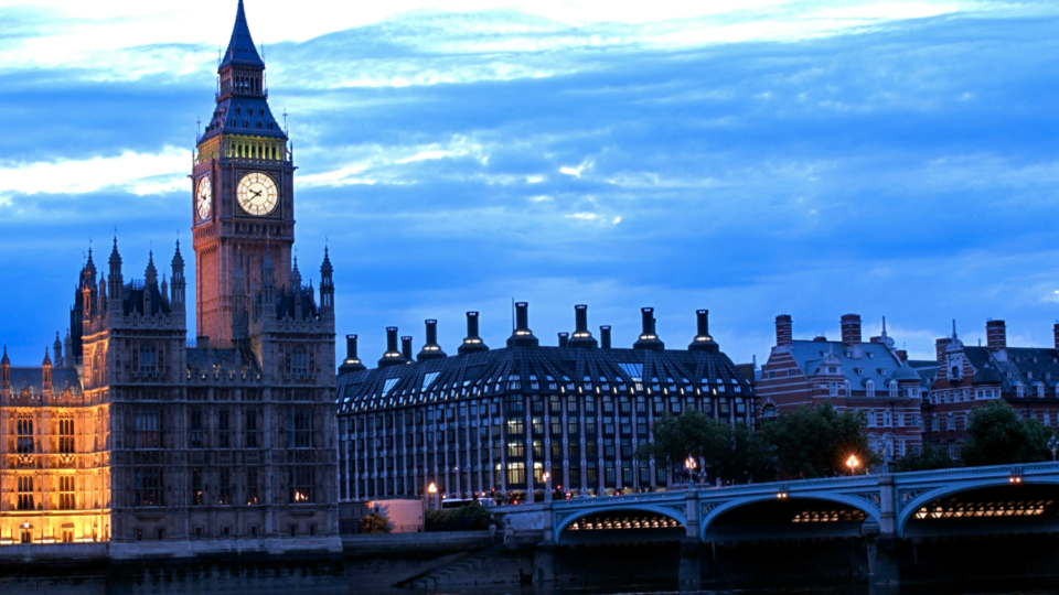 UK Parliament building at dusk.