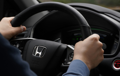 Person driving Honda car.