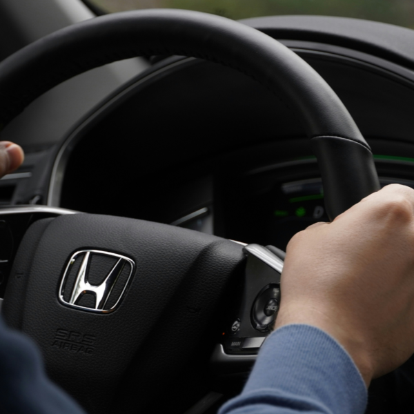 Person driving Honda car.