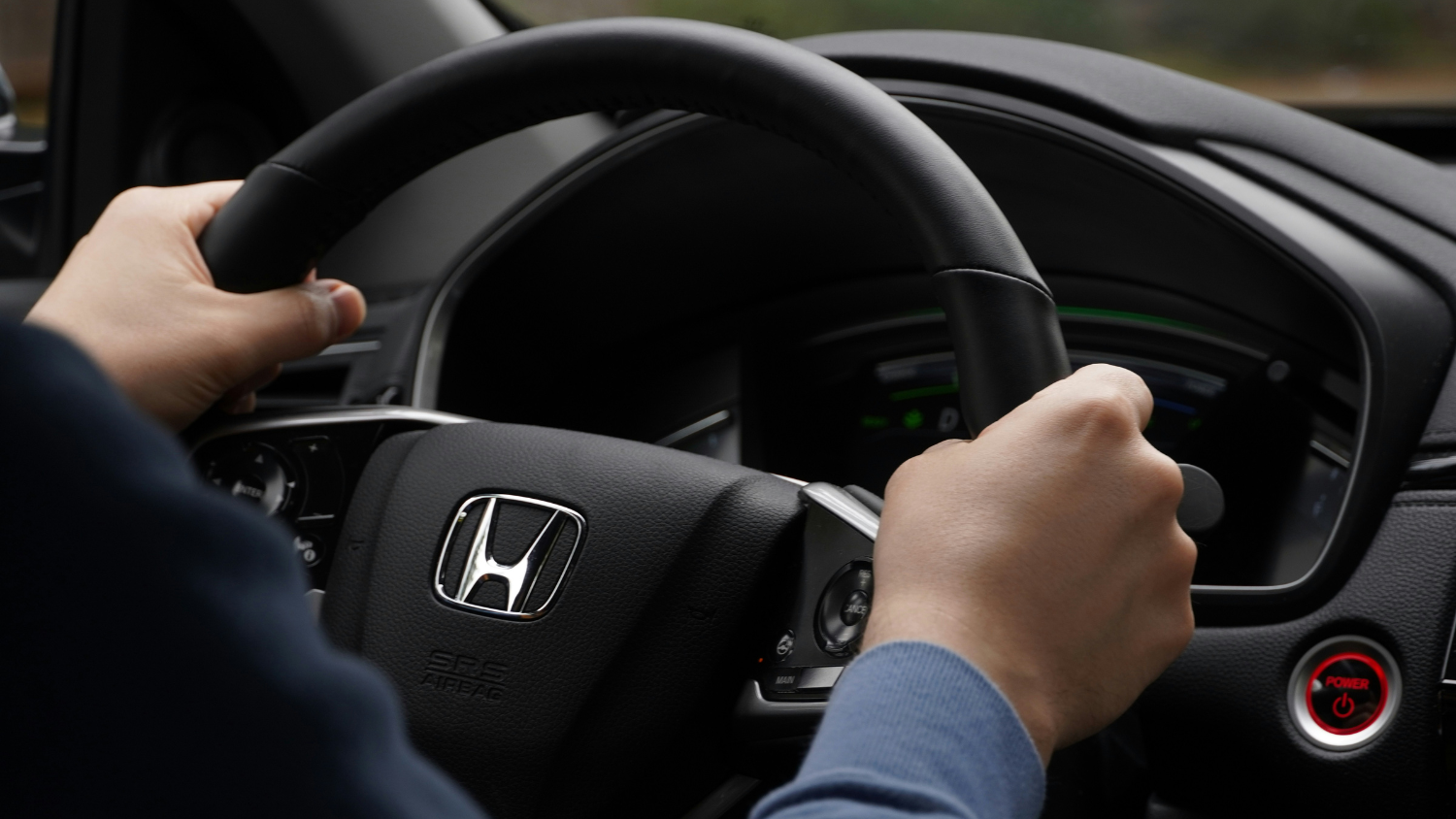 Person driving Honda car.