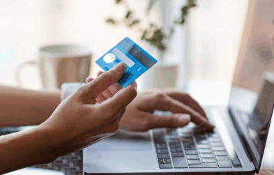 Person at laptop using credit card