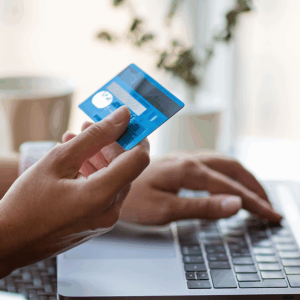 Person at laptop using credit card