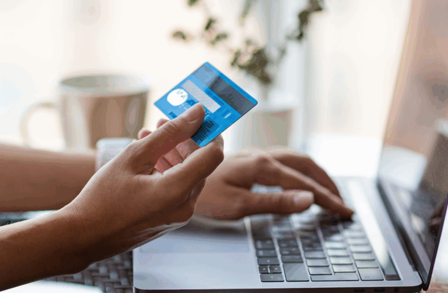 Person at laptop using credit card