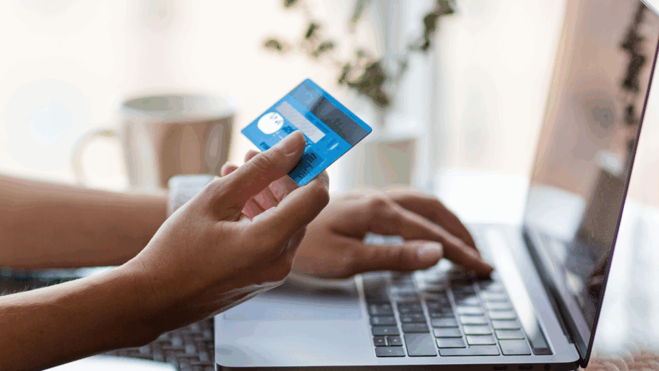 Person at laptop using credit card